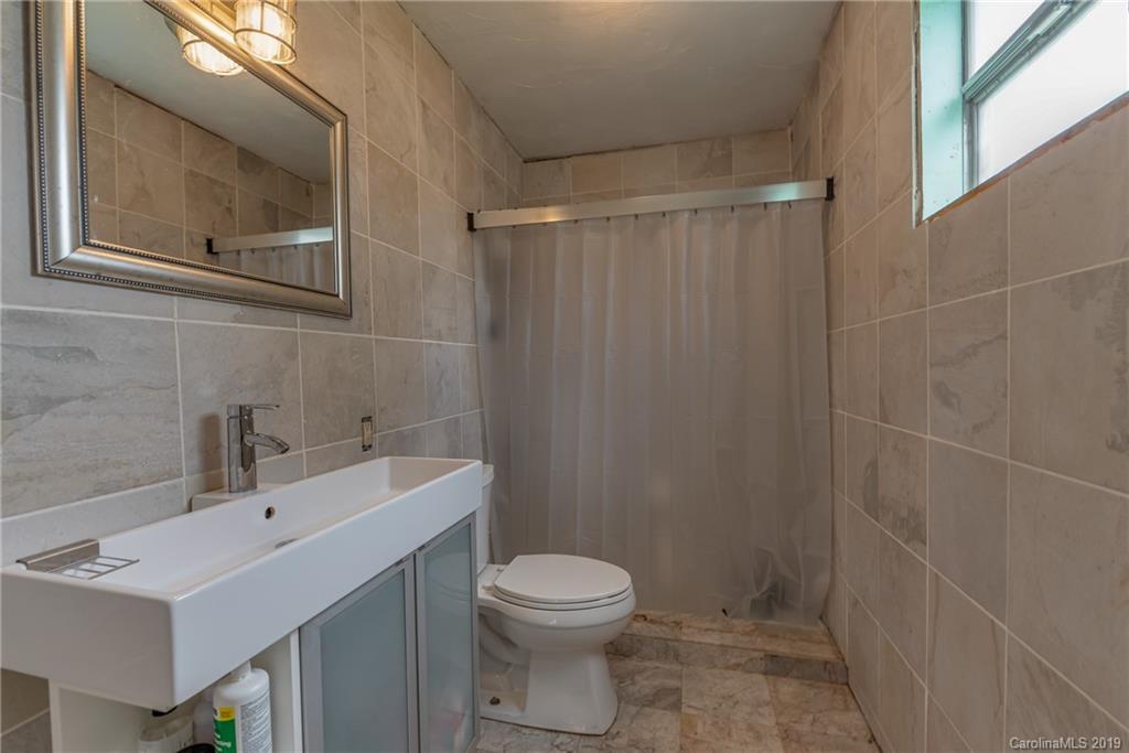 265 Carson Street Tryon, NC 28782 - Photo 15 of 28 a bathroom with a sink a toilet and shower