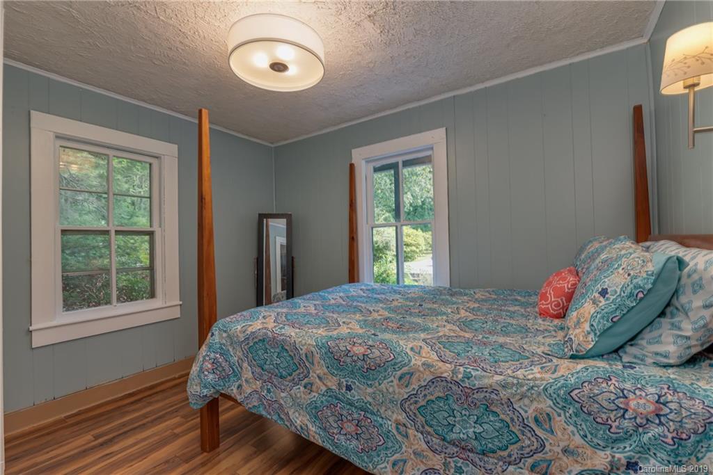 265 Carson Street Tryon, NC 28782 - Photo 16 of 28 a bedroom with a bed and a window