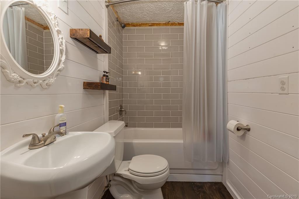 265 Carson Street Tryon, NC 28782 - Photo 18 of 28 a bathroom with a sink a toilet and shower