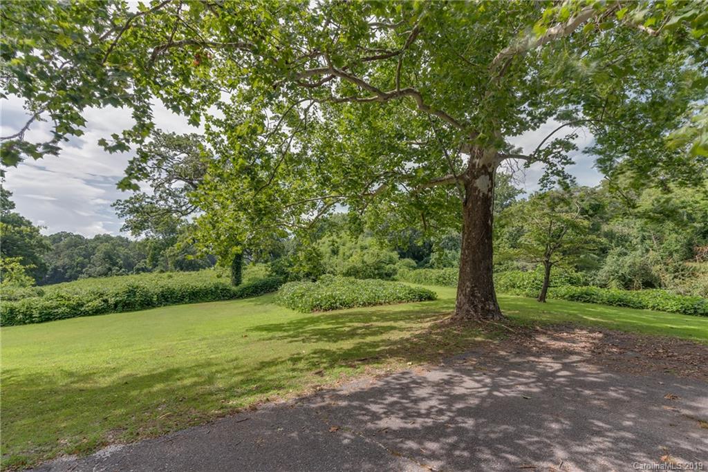 265 Carson Street Tryon, NC 28782 - Photo 3 of 28 a view of a field with a tree