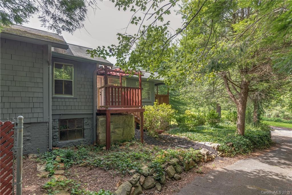 265 Carson Street Tryon, NC 28782 - Photo 25 of 28 a front view of a house with garden