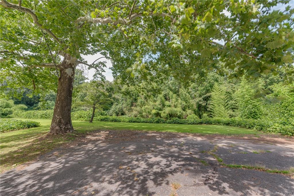 265 Carson Street Tryon, NC 28782 - Photo 4 of 28 a view of a field with trees in the background