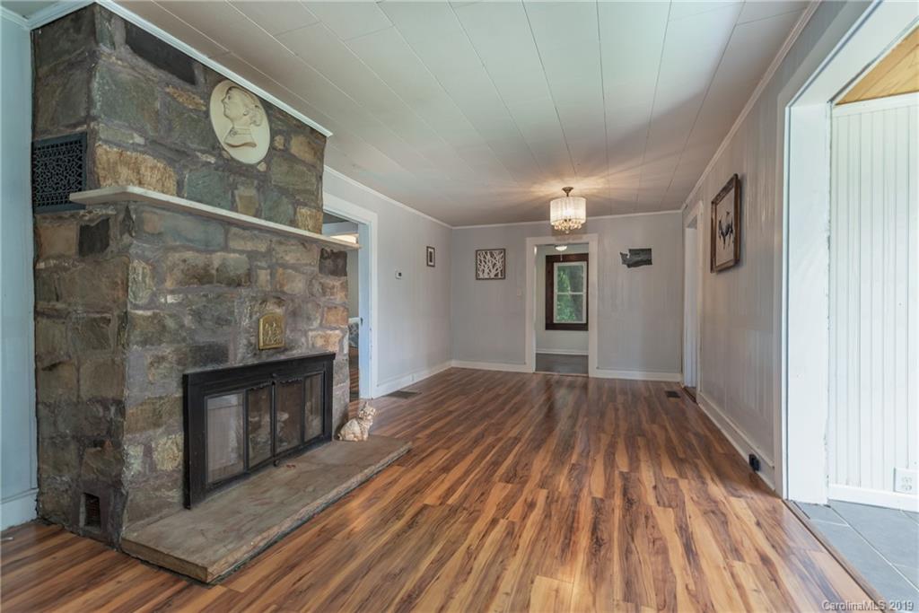 265 Carson Street Tryon, NC 28782 - Photo 7 of 28 a view of empty room with wooden floor and fireplace