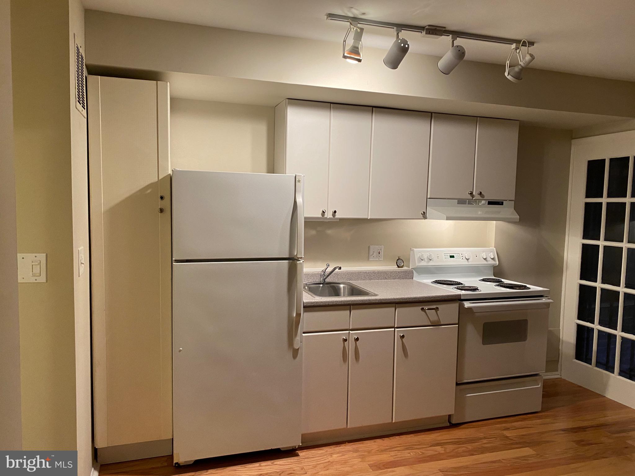 339 11th Street Southeast Washington, DC 20003 - Photo 9 of 39 a kitchen with appliances a sink and cabinets