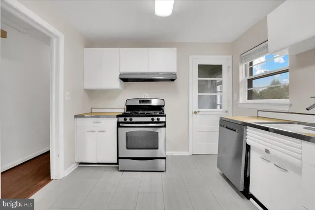 a kitchen with stainless steel appliances a stove a sink and a refrigerator