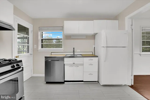 a kitchen with appliances a sink and a window