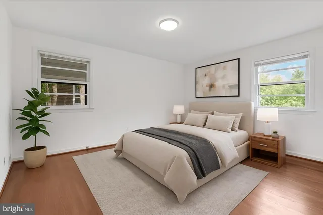 a bedroom with a bed and a potted plant