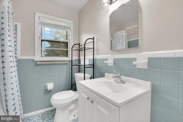 a bathroom with a sink a toilet and mirror