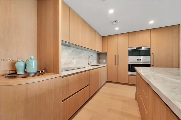 a kitchen with stainless steel appliances granite countertop a sink and a stove