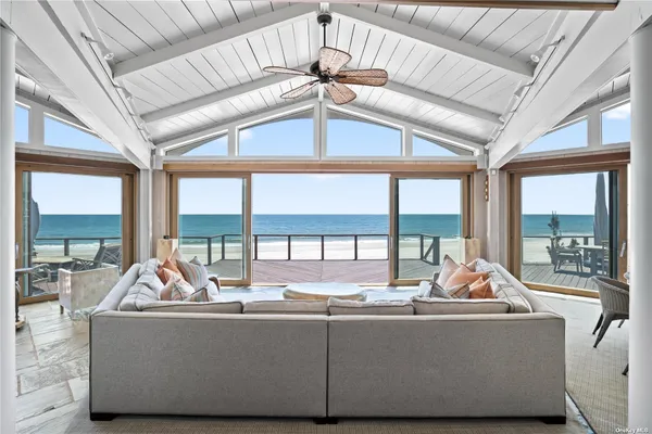 a living room with furniture next to a large window