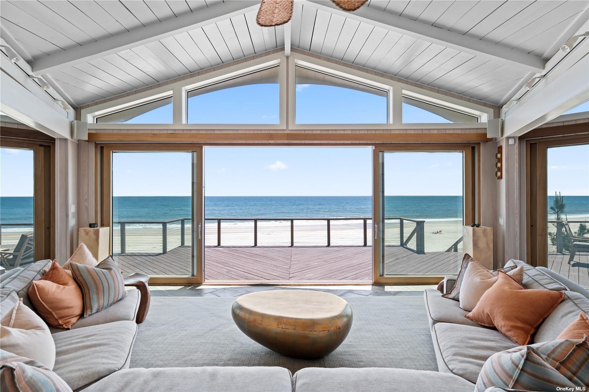 174 Dune Road Quogue, NY 11959 - Photo 2 of 35 a living room with furniture and a large window