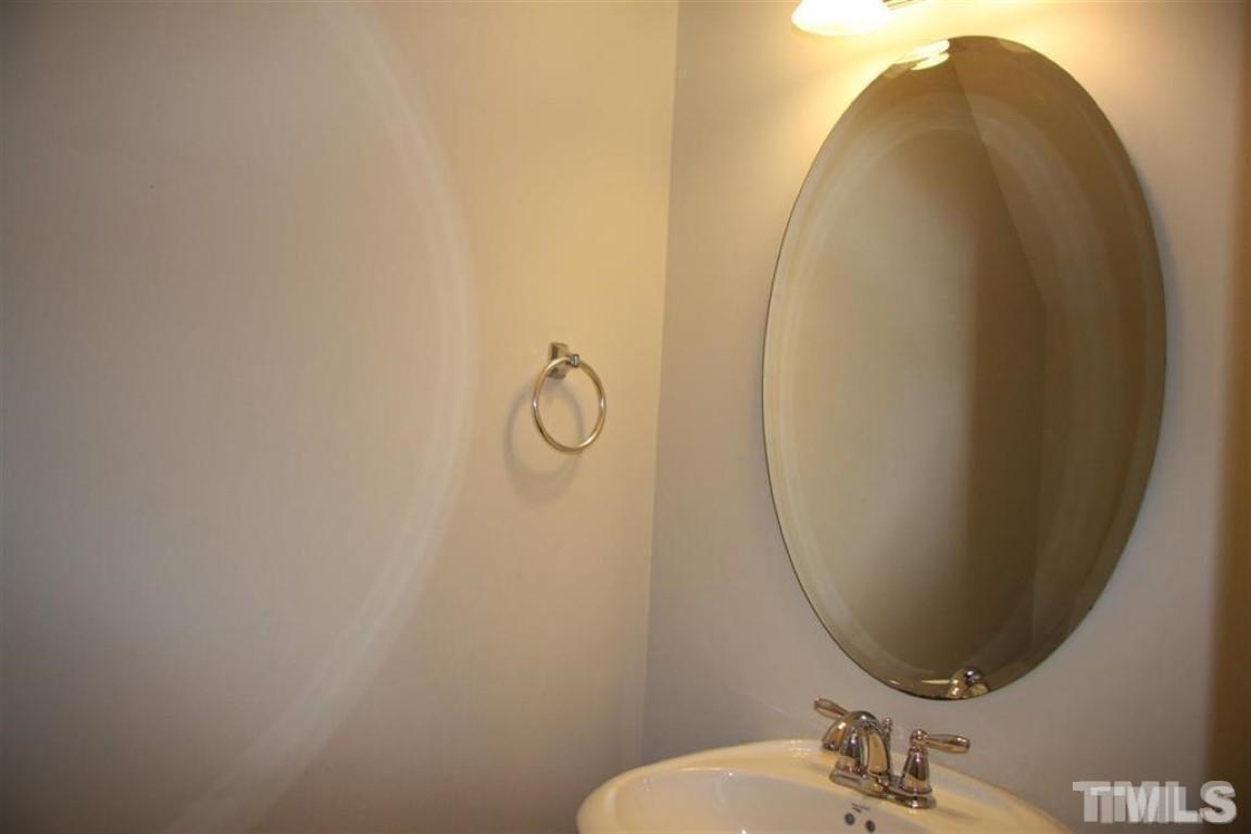 139 Skyros Loop Cary, NC 27519 - Photo 11 of 30 a bathroom with a sink and mirror