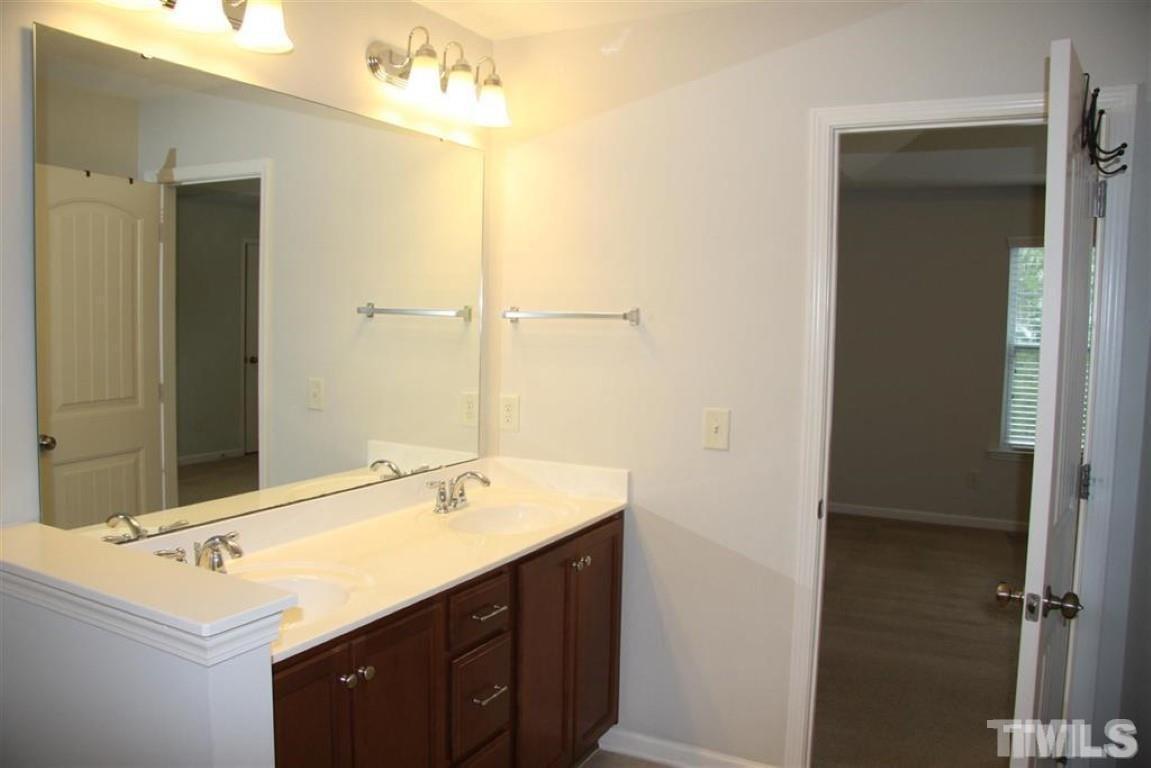 139 Skyros Loop Cary, NC 27519 - Photo 17 of 30 a bathroom with a sink and a mirror