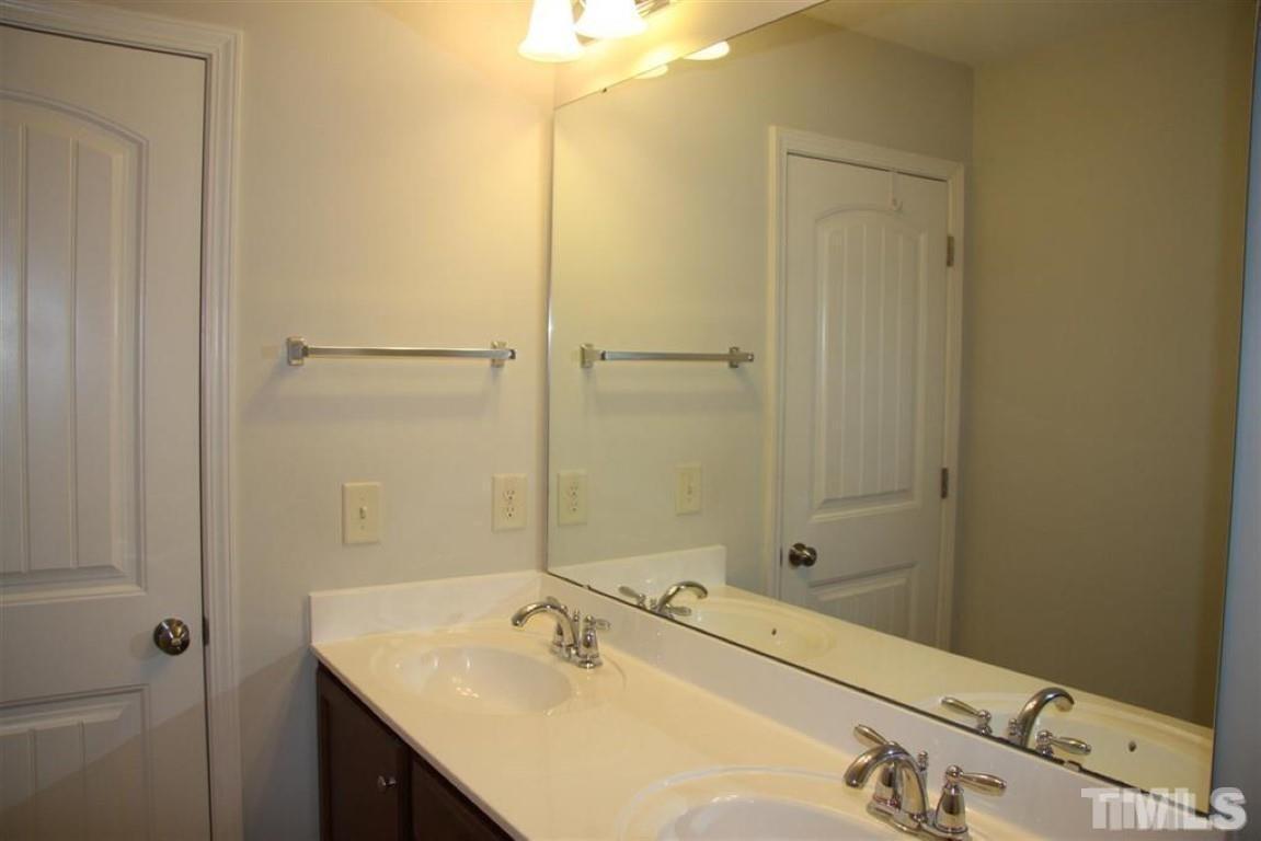 139 Skyros Loop Cary, NC 27519 - Photo 21 of 30 a bathroom with a sink and a mirror