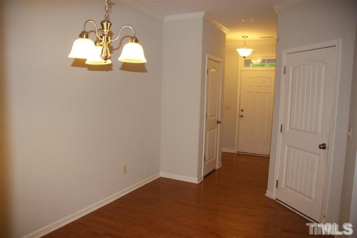 139 Skyros Loop Cary, NC 27519 - Photo 3 of 30 wooden floor in an empty room with a mirror