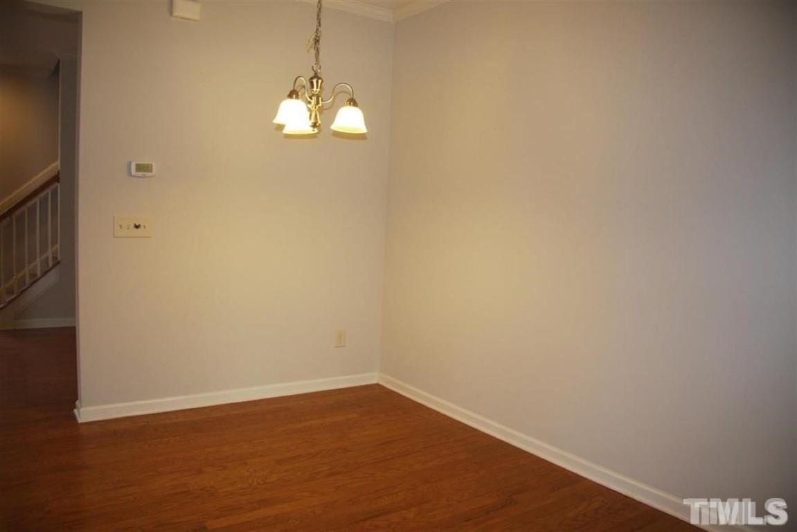 139 Skyros Loop Cary, NC 27519 - Photo 4 of 30 a view of empty room with wooden floor and fan