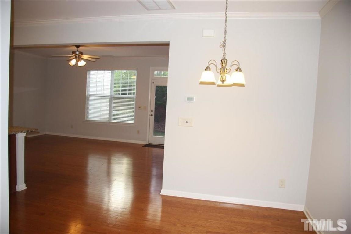 139 Skyros Loop Cary, NC 27519 - Photo 5 of 30 a view of a room with wooden floor and windows