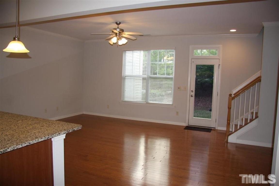 139 Skyros Loop Cary, NC 27519 - Photo 9 of 30 a view of an empty room with wooden floor and a window
