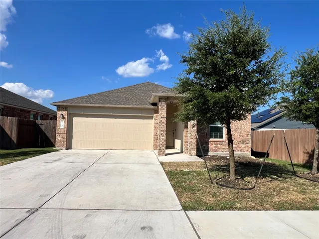 a backyard of a house with table and chairs