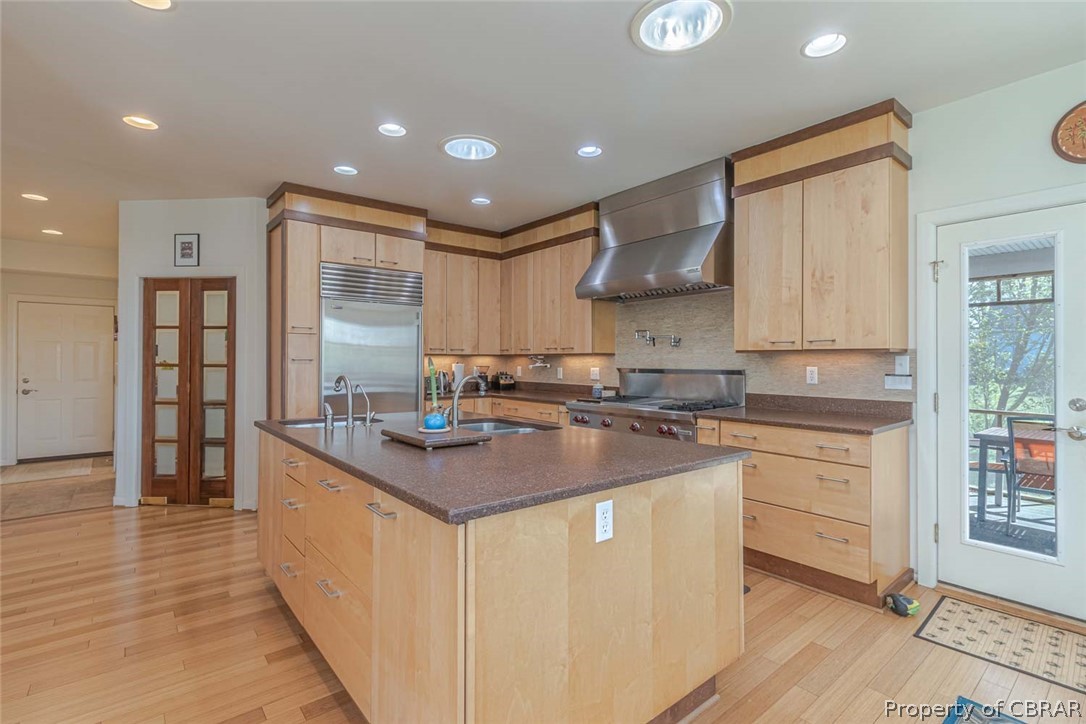 364 Captains Way Reedville, VA 22539 - Photo 24 of 50 Chef's Welcome! Fabulous over the top gourmet Kitchen! Customized maple cabinets, Silostone countertops, Wolf/Subzero appliances, 2 Sinks, & those wooden doors to the left are to the walk-in pantry with extra fridge.