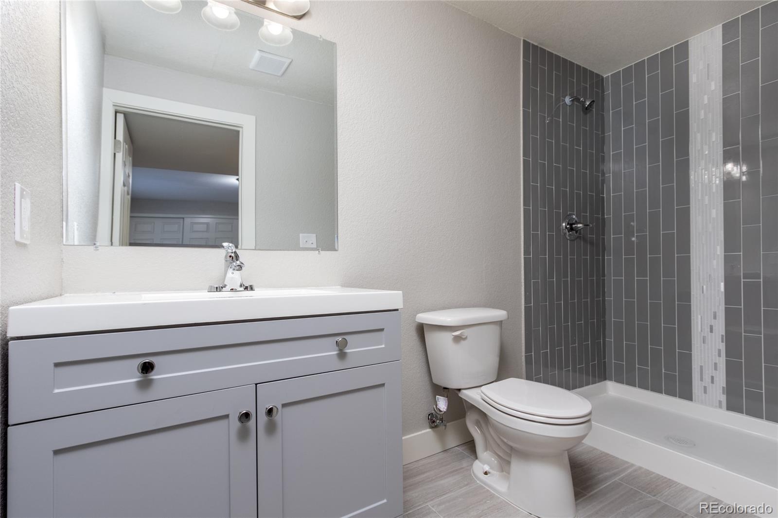 1589 Spring Water Way Highlands Ranch, CO 80129 - Photo 13 of 40 a bathroom with a sink a toilet and shower