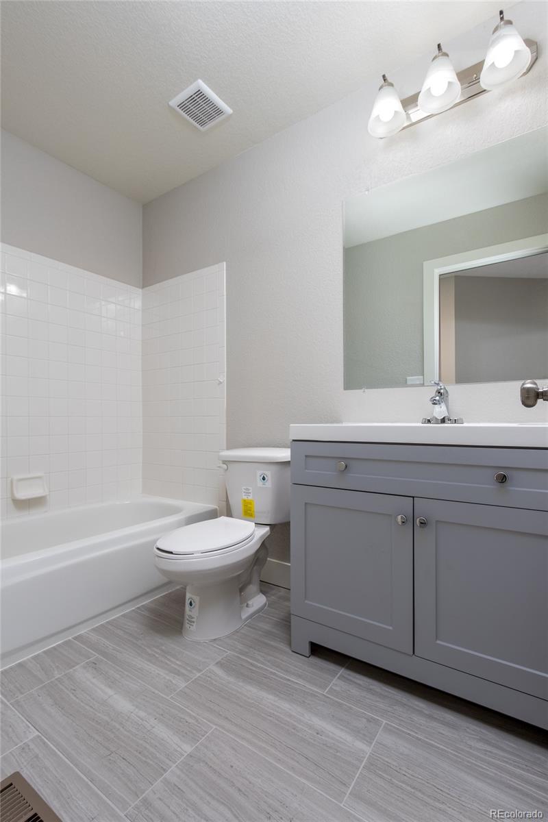 1589 Spring Water Way Highlands Ranch, CO 80129 - Photo 23 of 40 a bathroom with a sink a toilet and a bathtub