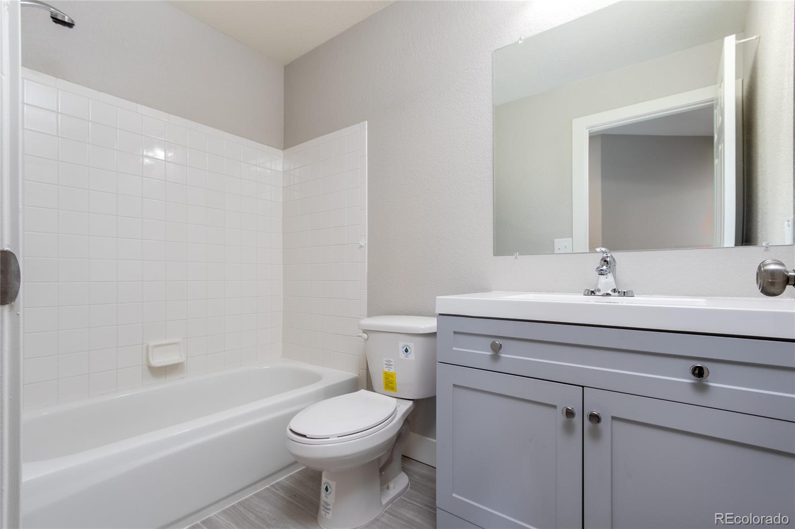 1589 Spring Water Way Highlands Ranch, CO 80129 - Photo 25 of 40 a bathroom with a sink a toilet and shower