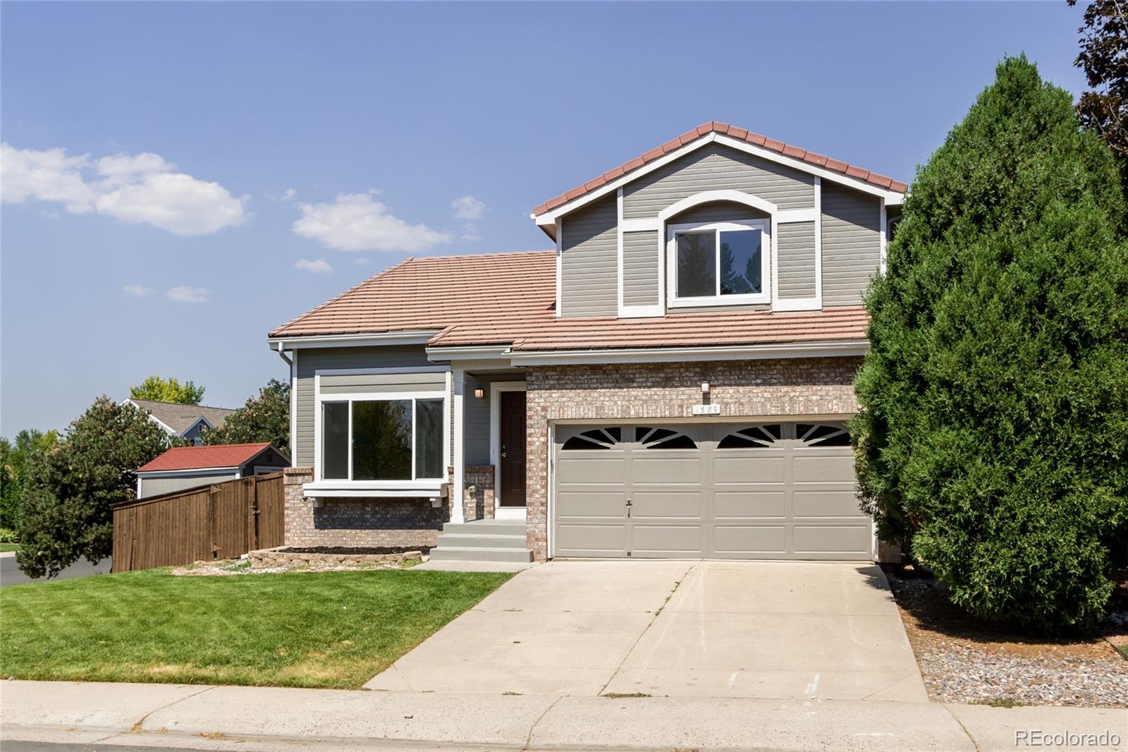 1589 Spring Water Way Highlands Ranch, CO 80129 - Photo 30 of 40 a front view of a house with a yard and trees