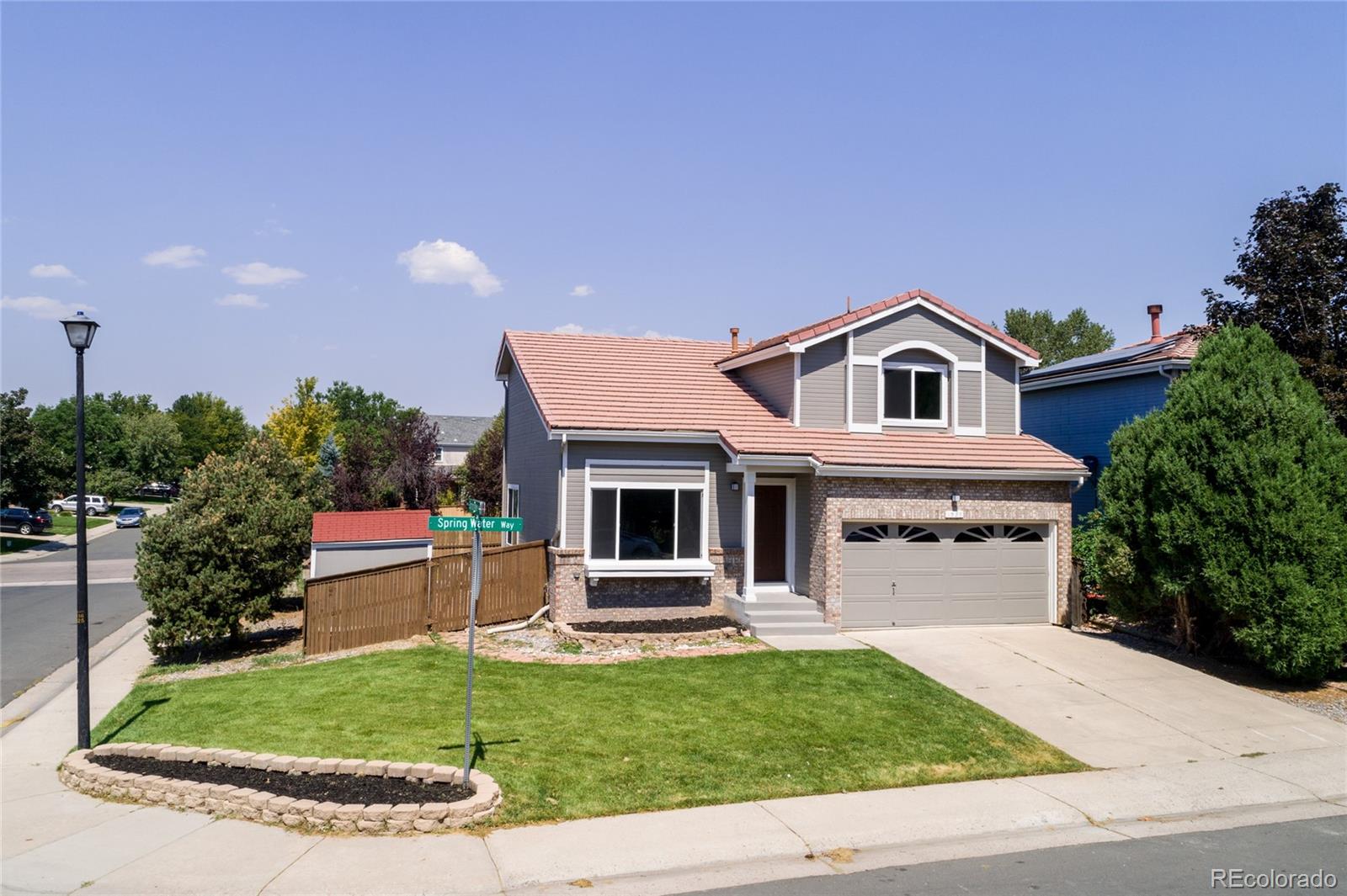 1589 Spring Water Way Highlands Ranch, CO 80129 - Photo 3 of 40 a front view of a house with a yard