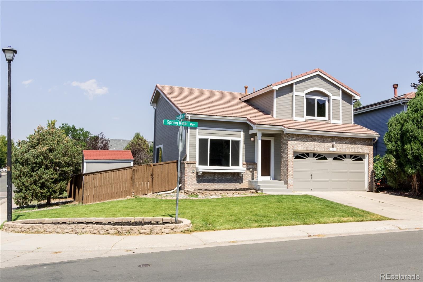 1589 Spring Water Way Highlands Ranch, CO 80129 - Photo 31 of 40 a front view of a house with a yard and garage