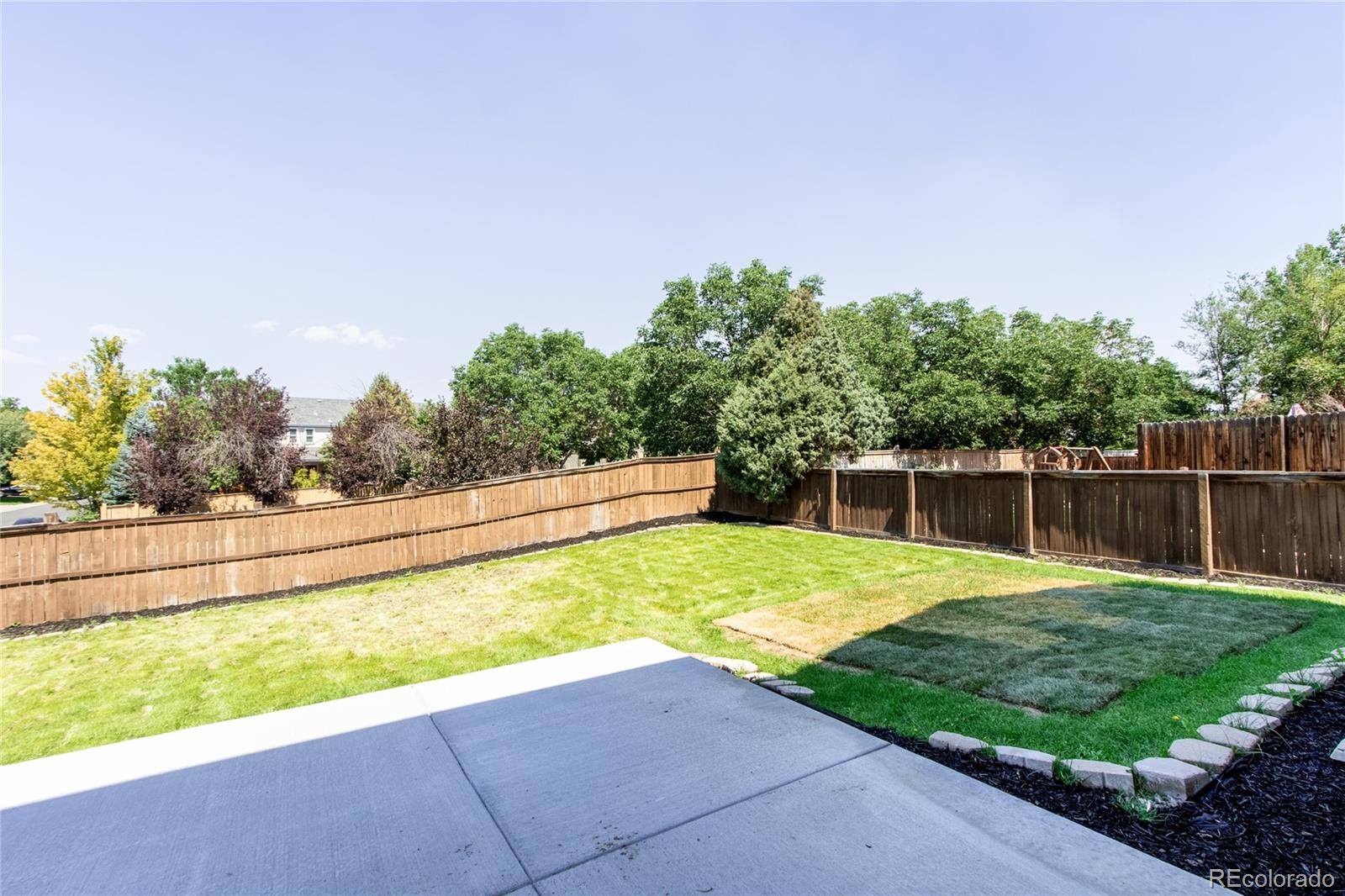 1589 Spring Water Way Highlands Ranch, CO 80129 - Photo 33 of 40 a view of a backyard with plants and lake view