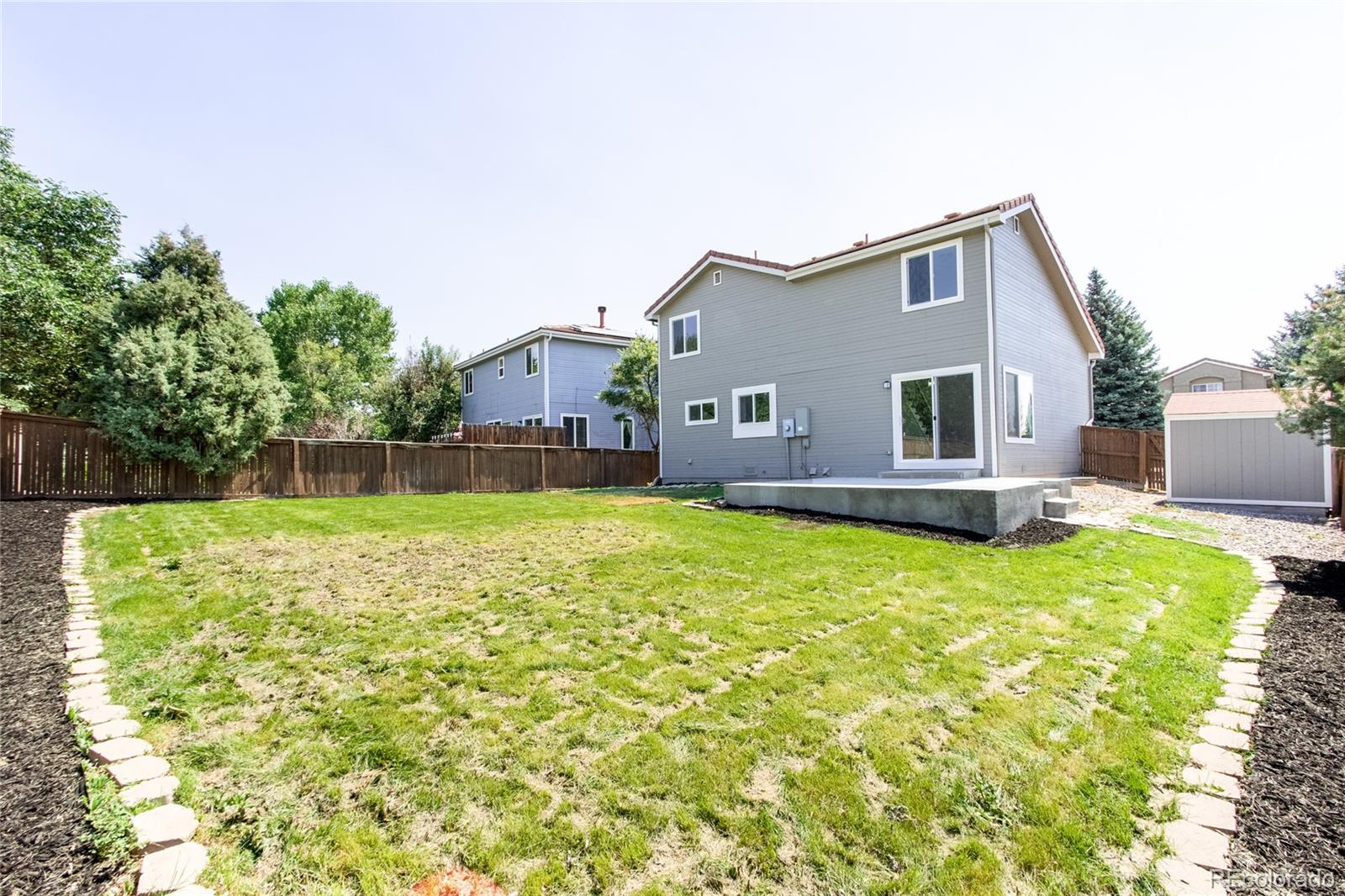 1589 Spring Water Way Highlands Ranch, CO 80129 - Photo 37 of 40 a backyard of a house with table and chairs