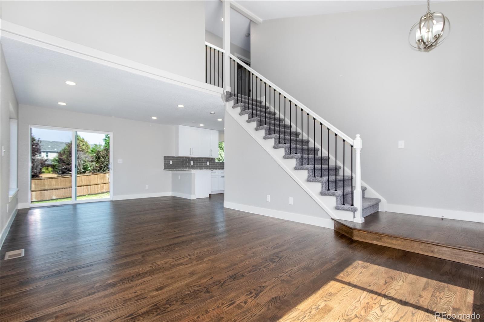 1589 Spring Water Way Highlands Ranch, CO 80129 - Photo 6 of 40 a view of an entryway with wooden floor