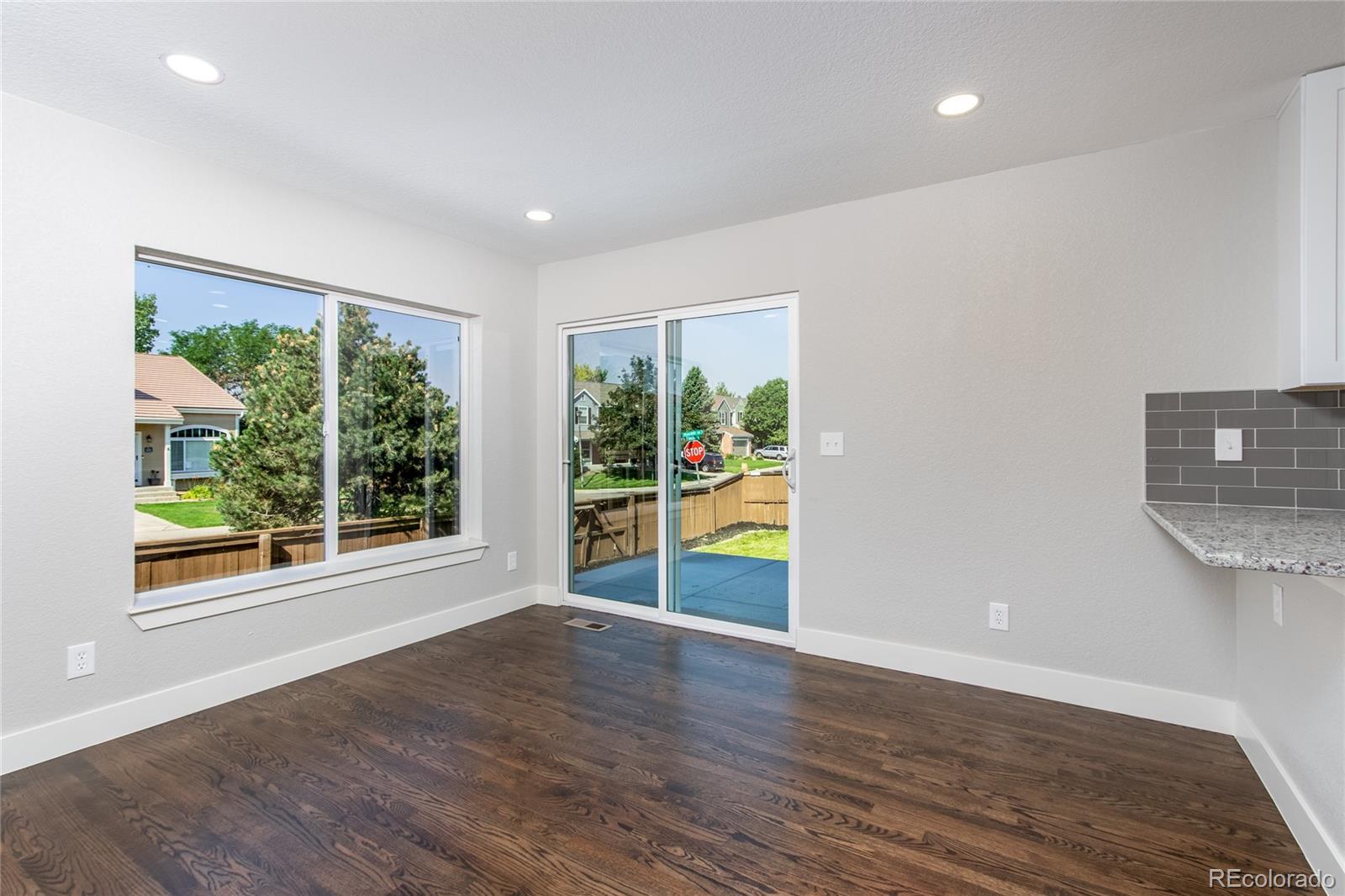 1589 Spring Water Way Highlands Ranch, CO 80129 - Photo 8 of 40 a view of an empty room with wooden floor and a window