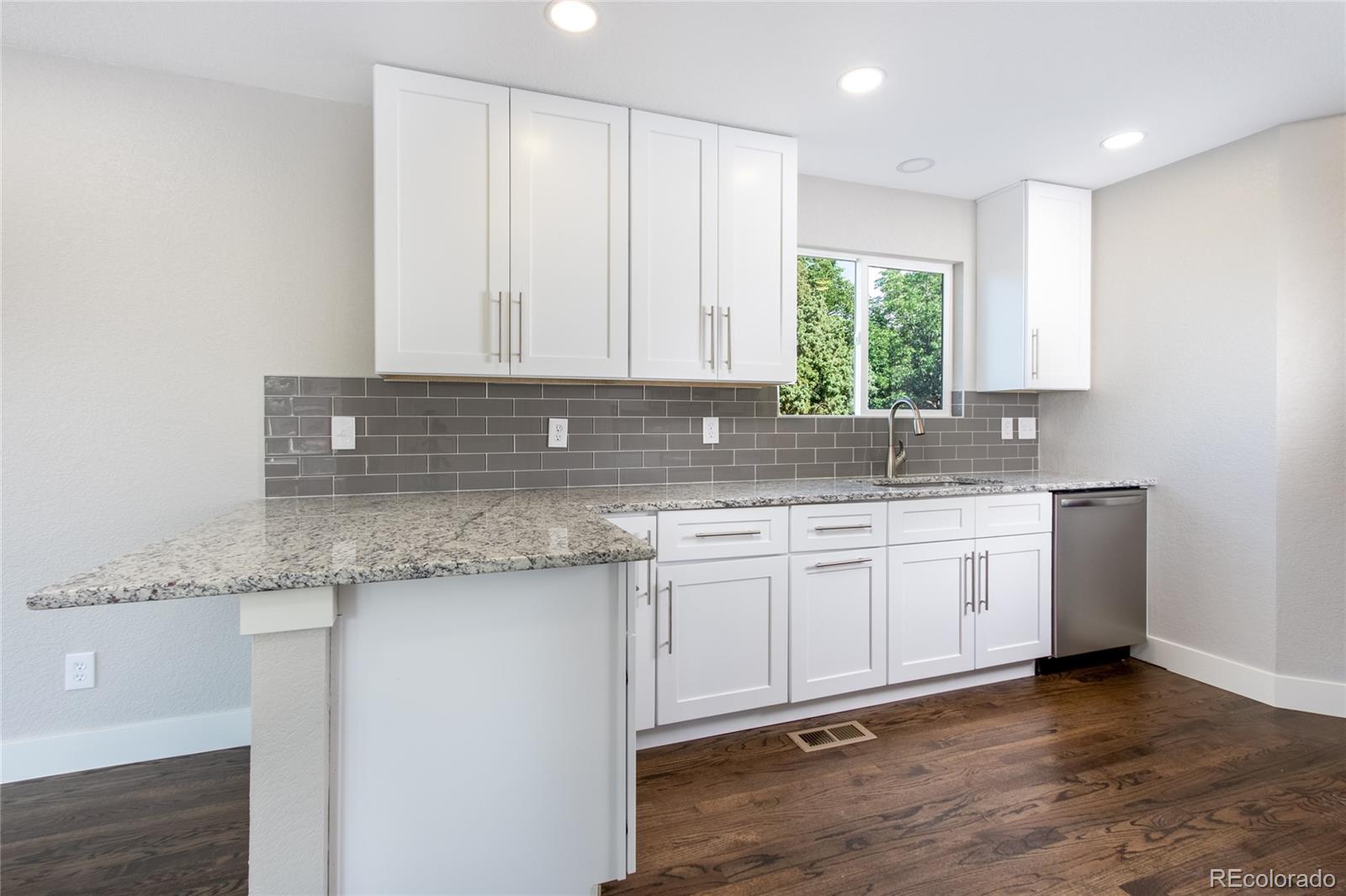 1589 Spring Water Way Highlands Ranch, CO 80129 - Photo 10 of 40 a kitchen with granite countertop cabinets sink and window