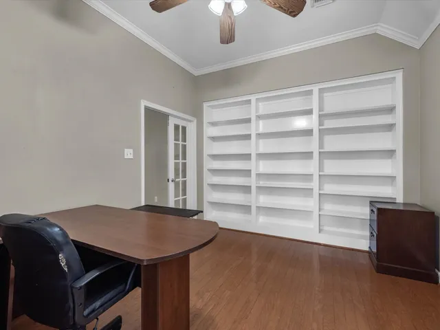 a view of a room with a furniture and a ceiling fan