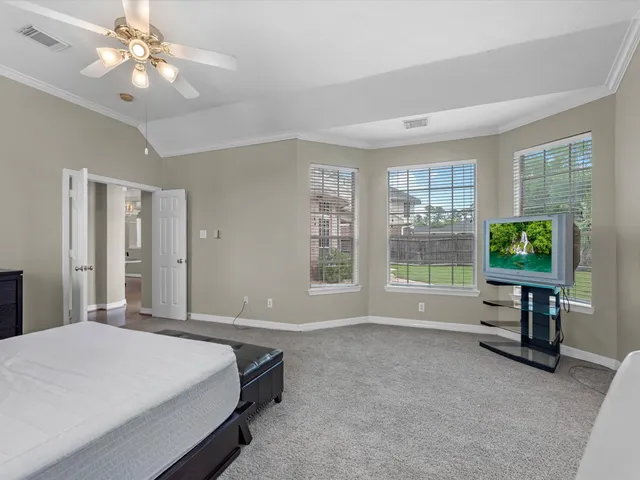 a spacious bedroom with a bed and a table in it