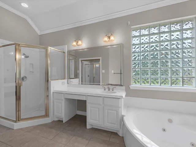 a bathroom with a bathtub a sink a vanity and a shower