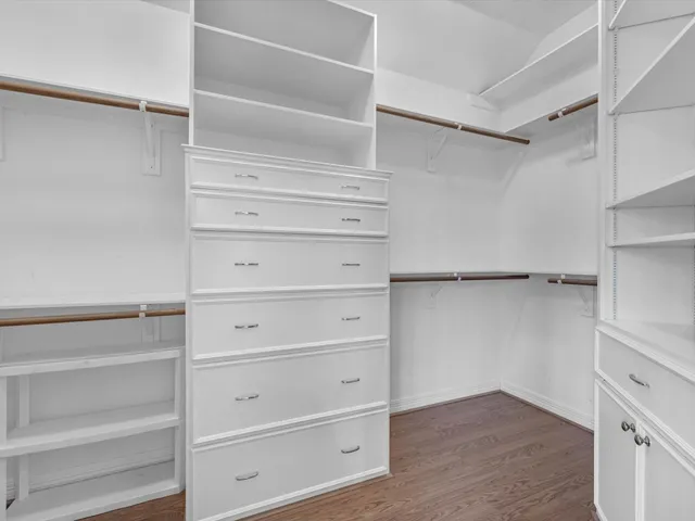 a view of walk in closet with empty racks