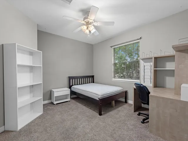a room with pool table and windows
