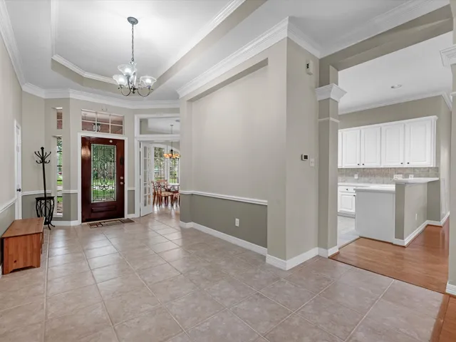 a view of a kitchen with a sink and refrigerator cabinets