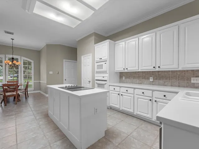 a kitchen with granite countertop cabinets a sink and a stove