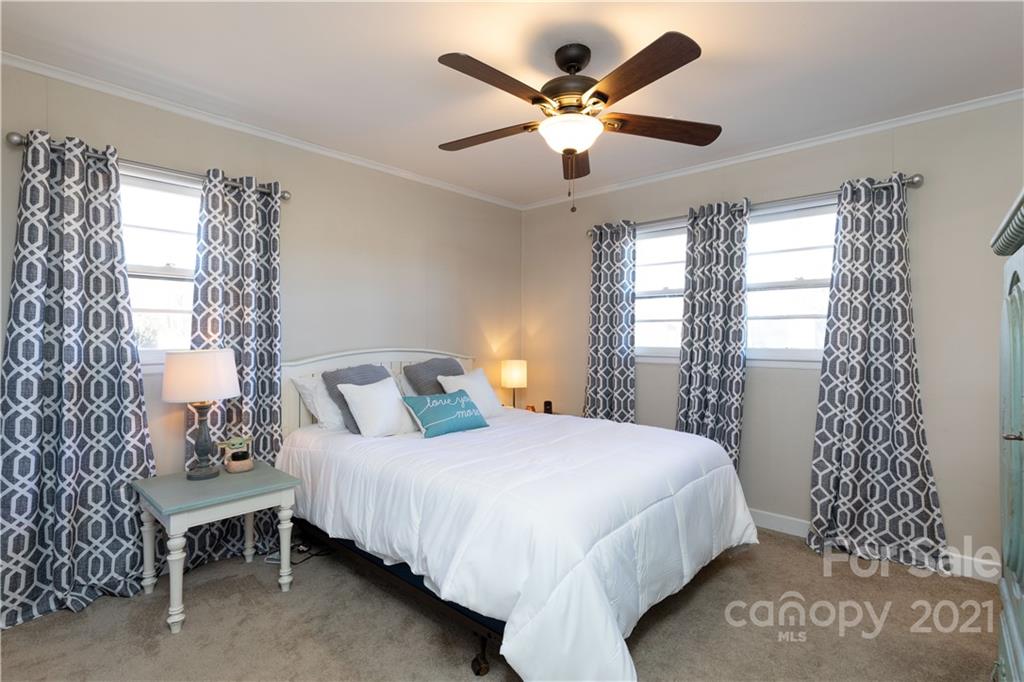 310 West Rambo Road Rock Hill, SC 29730 - Photo 12 of 26 a bedroom with a bed and a chandelier