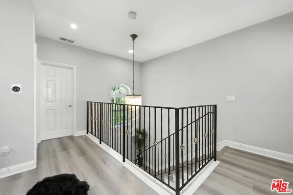 a view of a hallway with a hardwood floor