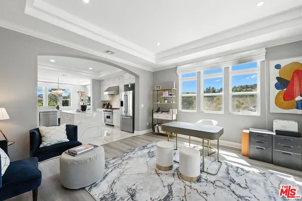 a living room with furniture a rug and white walls