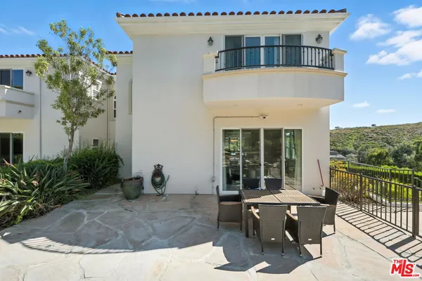 a view of a house with sitting area and garden