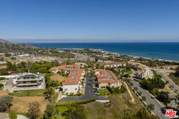 an aerial view of residential building and ocean view