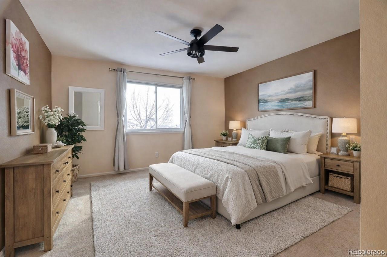 3819 South Rome Way Aurora, CO 80018 - Photo 14 of 32 a spacious bedroom with a bed and a chandelier