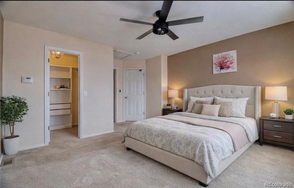 3819 South Rome Way Aurora, CO 80018 - Photo 16 of 32 a bedroom with a bed and a table