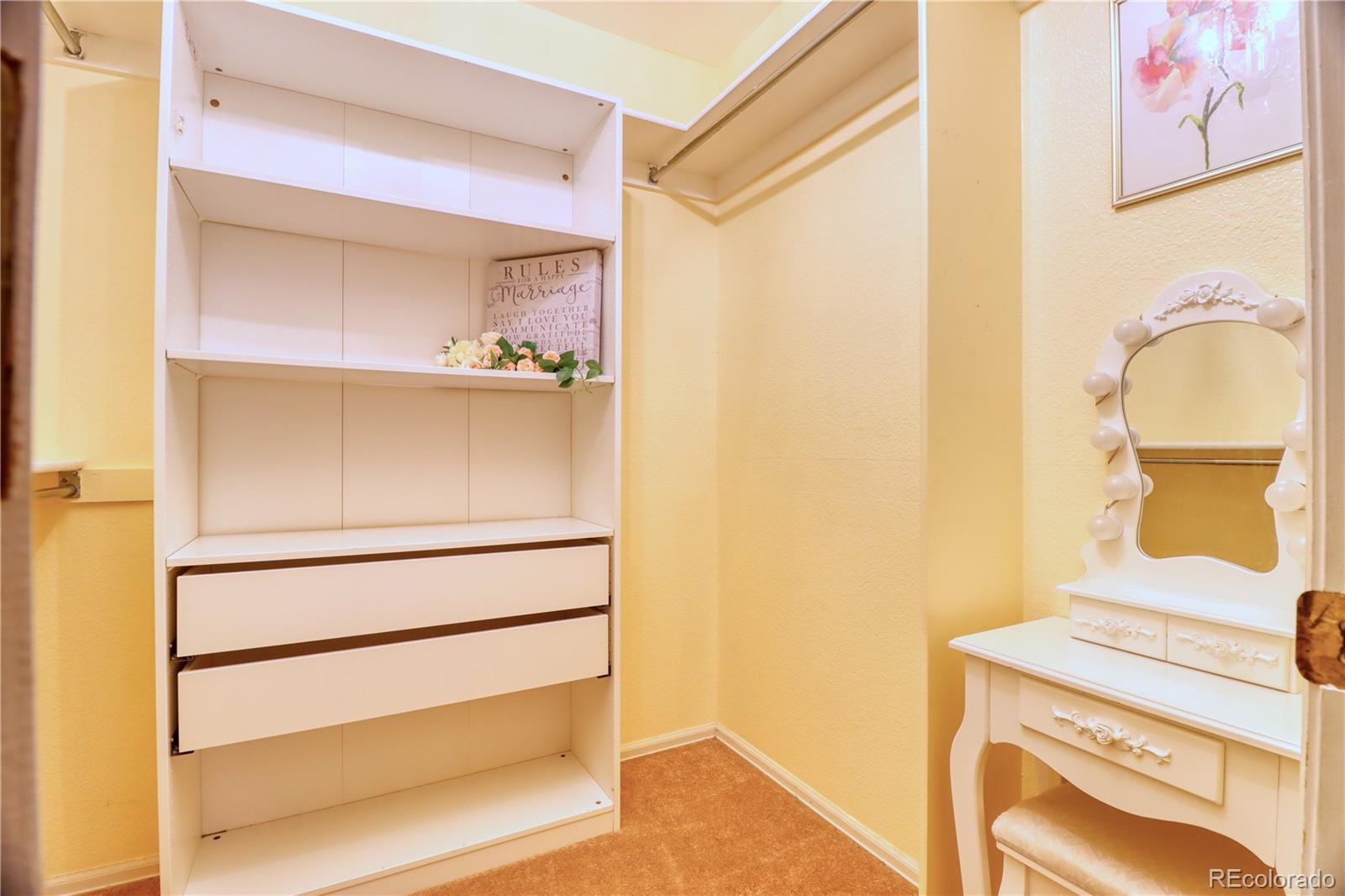 3819 South Rome Way Aurora, CO 80018 - Photo 17 of 32 a view of walk in closet with empty racks